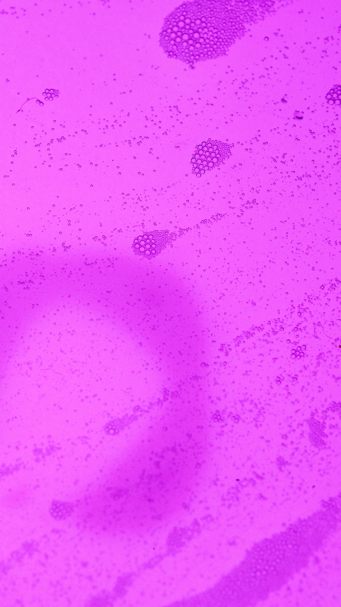 Vibrant abstract close-up of pink bubbles creating an artistic texture with copyspace.